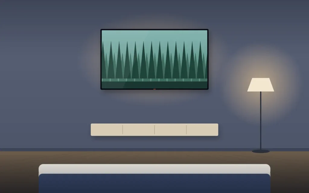 TV mounted on a bedroom wall above a dresser